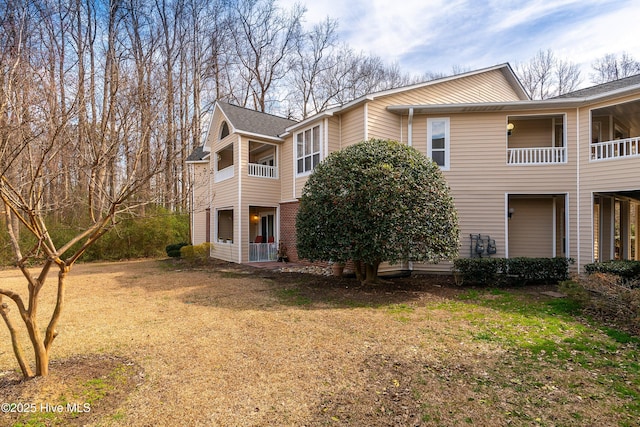 view of side of home with a lawn