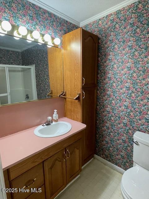 full bath featuring a shower stall, wallpapered walls, toilet, and ornamental molding