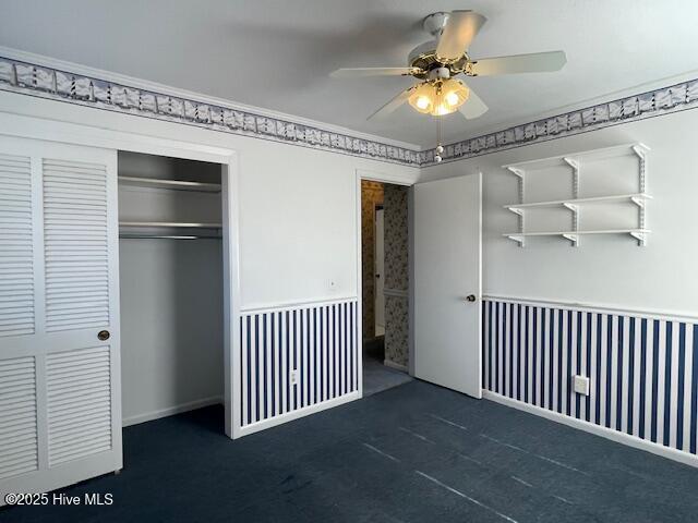 unfurnished bedroom with a ceiling fan and a closet