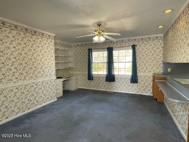 unfurnished living room with dark carpet, wallpapered walls, baseboards, and ornamental molding