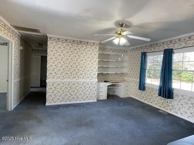 interior space with wallpapered walls, crown molding, and dark carpet