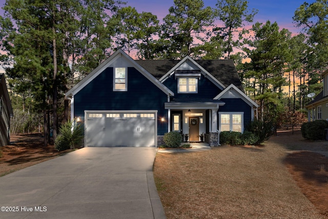 craftsman house featuring an attached garage and driveway