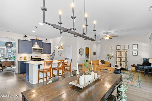 dining room with a ceiling fan, recessed lighting, wood finished floors, and baseboards