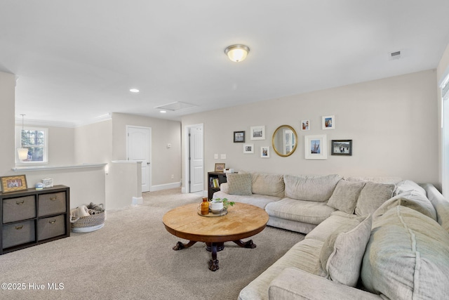 carpeted living area with recessed lighting, visible vents, and baseboards