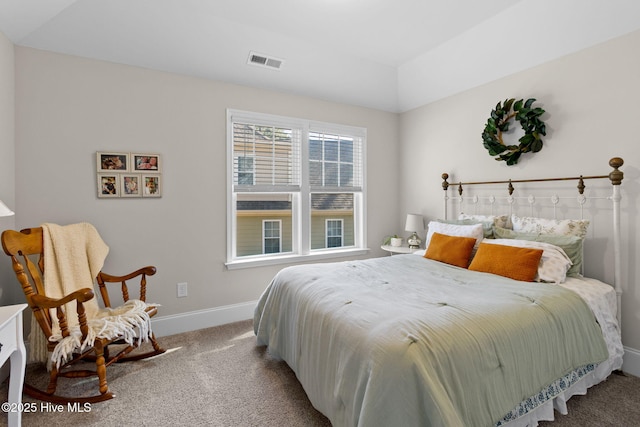 carpeted bedroom with visible vents, baseboards, and vaulted ceiling