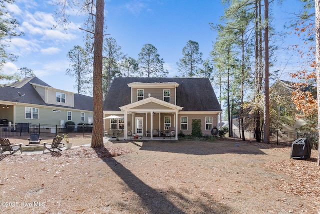 back of house featuring a patio, fence, and a fire pit