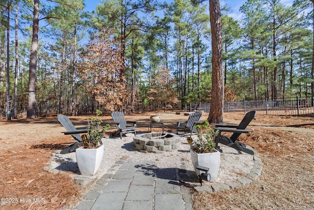 view of patio / terrace featuring an outdoor fire pit and fence