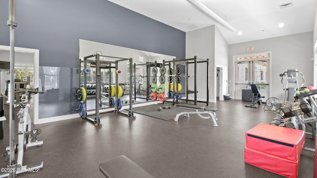 workout area featuring baseboards, visible vents, and french doors