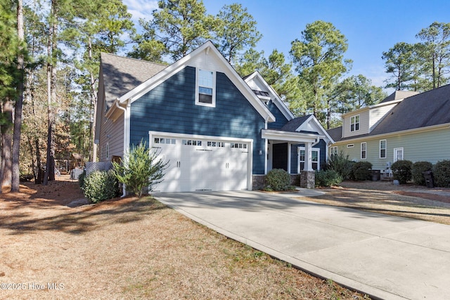 view of front of home with stone siding, a garage, driveway, and a shingled roof