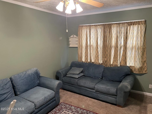 living area featuring a ceiling fan, a textured ceiling, carpet flooring, crown molding, and baseboards