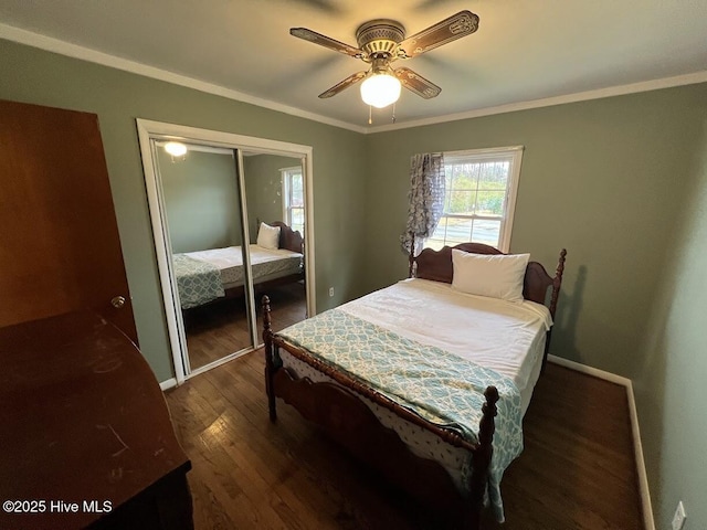 bedroom with a closet, crown molding, dark wood-type flooring, and ceiling fan