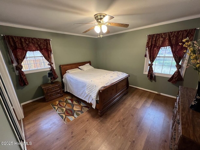 bedroom featuring ceiling fan, wood finished floors, baseboards, and ornamental molding