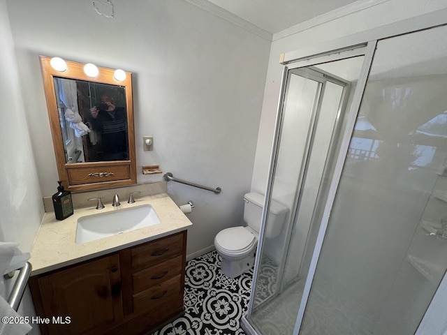 bathroom featuring vanity, a stall shower, ornamental molding, tile patterned flooring, and toilet