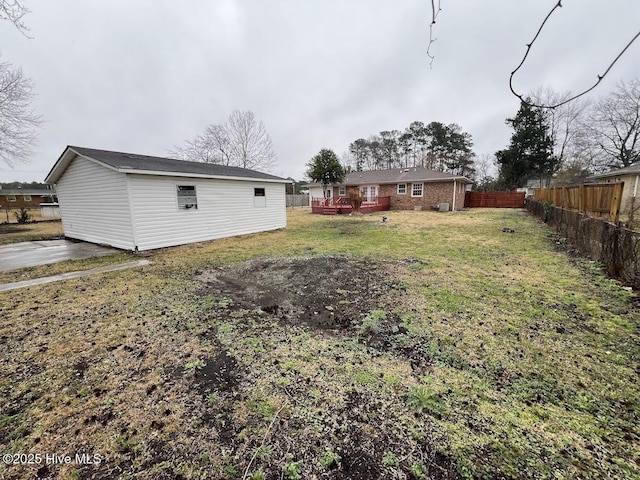 view of yard featuring fence and a wooden deck