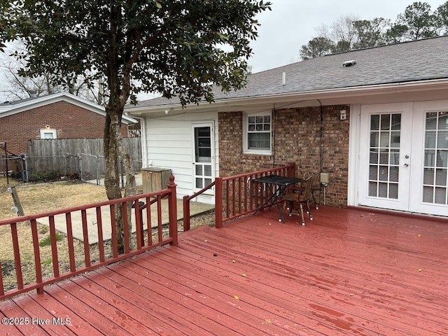 wooden deck featuring french doors, a yard, and fence