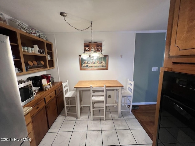 dining area featuring an inviting chandelier and baseboards