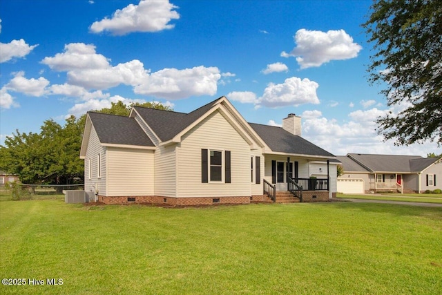 rear view of house with fence, central AC, a chimney, a yard, and crawl space