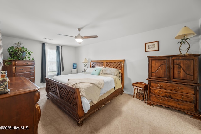 carpeted bedroom featuring baseboards and ceiling fan