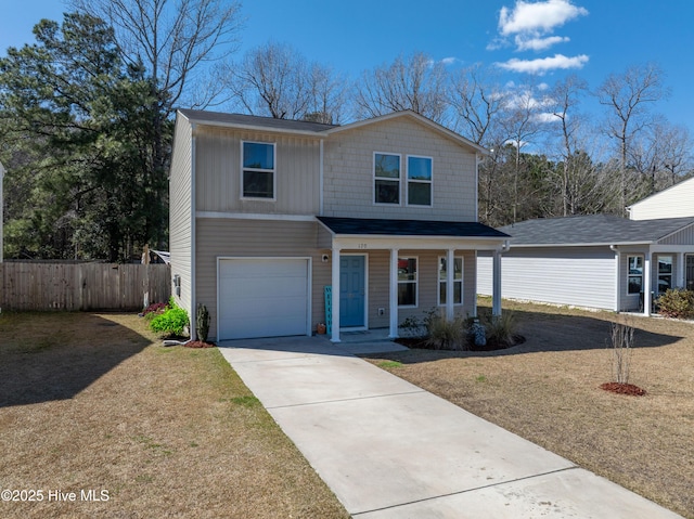 traditional-style home featuring a front yard, fence, driveway, a porch, and an attached garage