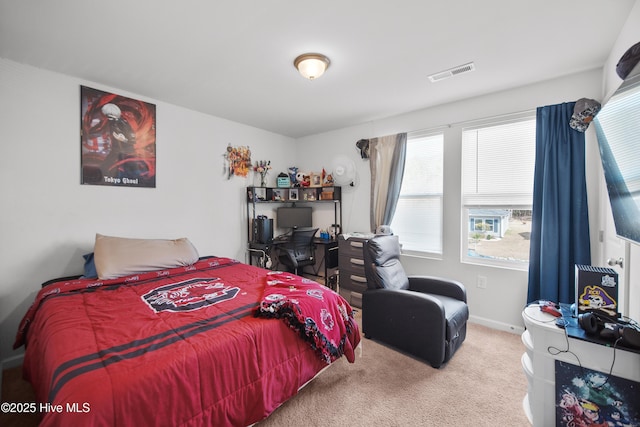 carpeted bedroom with visible vents and baseboards