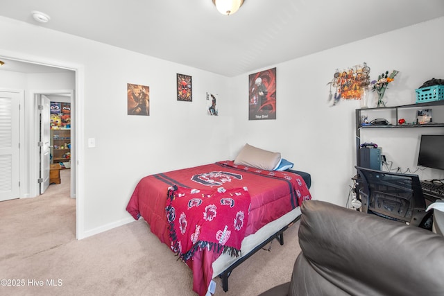 bedroom with baseboards and carpet