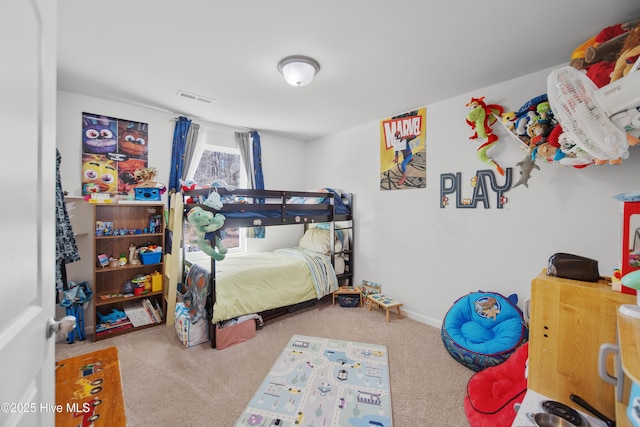 bedroom with visible vents and carpet flooring