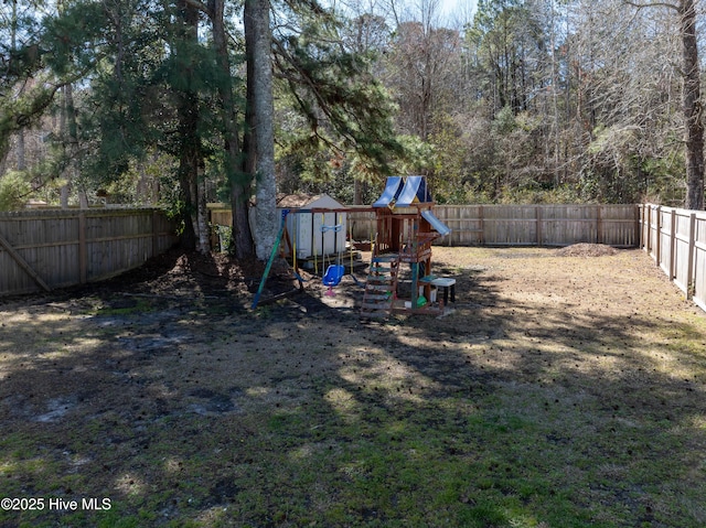 view of yard with a playground and a fenced backyard