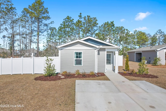 view of front of house with a front lawn and fence