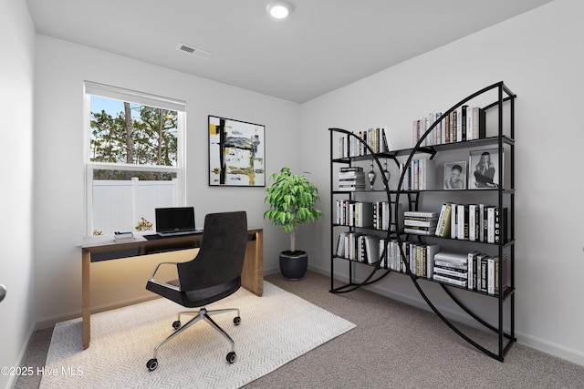 carpeted home office with baseboards and visible vents