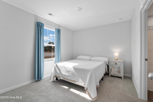 bedroom featuring visible vents, carpet flooring, and baseboards