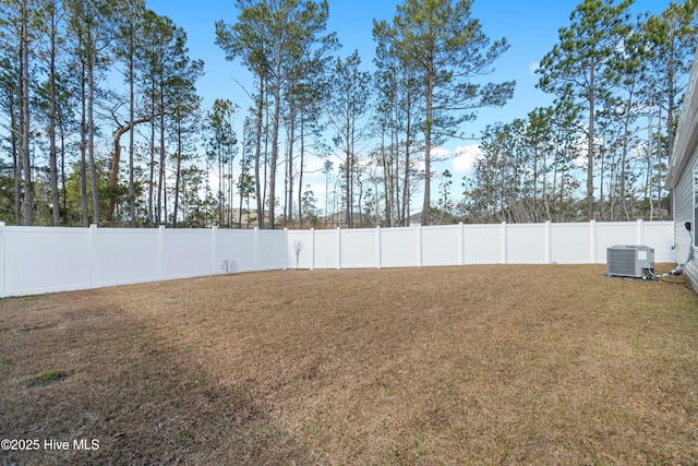 view of yard with cooling unit and a fenced backyard