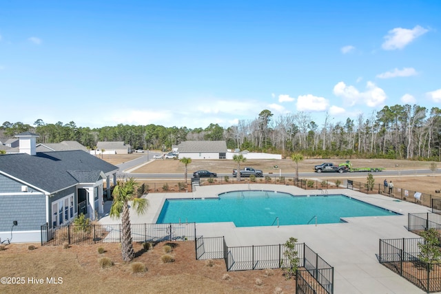 pool with a patio and fence