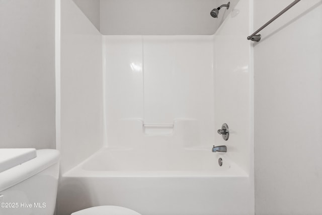 bathroom with tub / shower combination and toilet