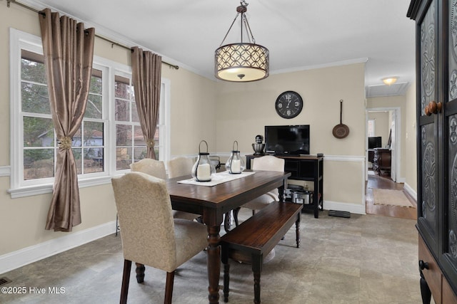 dining area featuring baseboards, a wealth of natural light, and ornamental molding