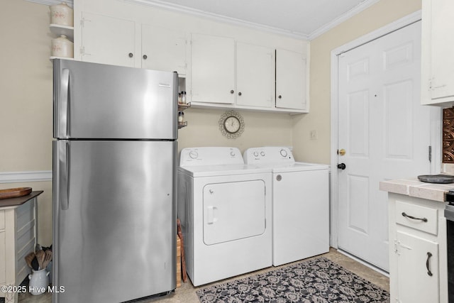 laundry area featuring washing machine and dryer, crown molding, and laundry area