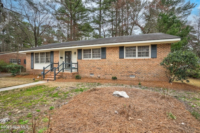 view of front of property with brick siding and crawl space