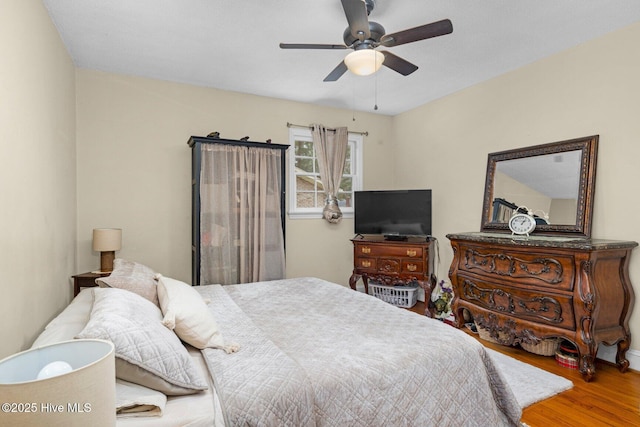 bedroom featuring a ceiling fan and wood finished floors