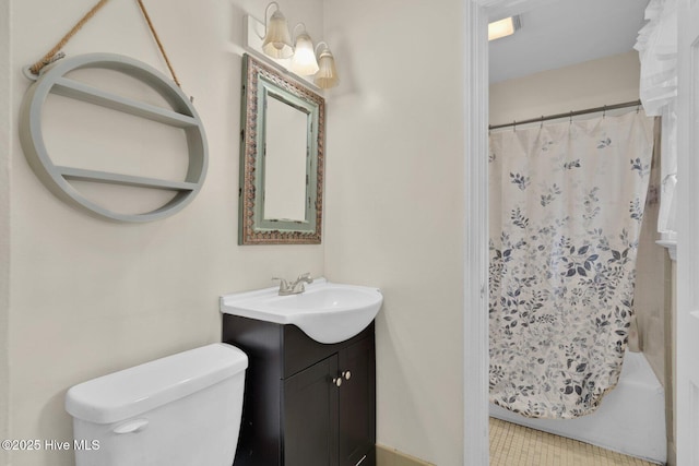 bathroom with toilet, vanity, and shower / bath combo with shower curtain