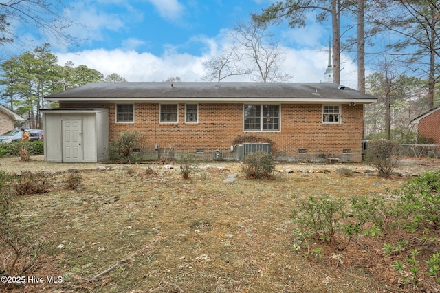 rear view of house featuring crawl space, central AC, and brick siding