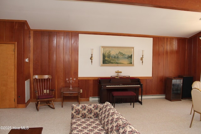 living area featuring visible vents, carpet floors, a baseboard radiator, wood walls, and baseboard heating