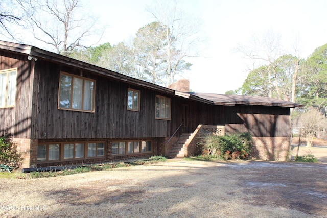 exterior space featuring stairway and a chimney