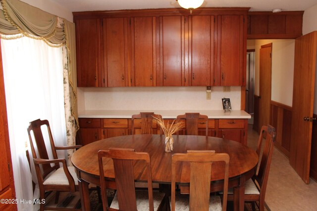 dining area with a wainscoted wall