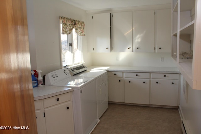 washroom featuring washer and dryer, cabinet space, light floors, and a baseboard heating unit