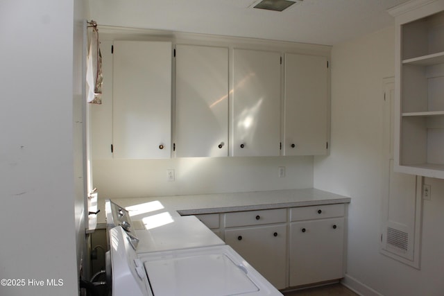 kitchen featuring open shelves, white cabinetry, and light countertops