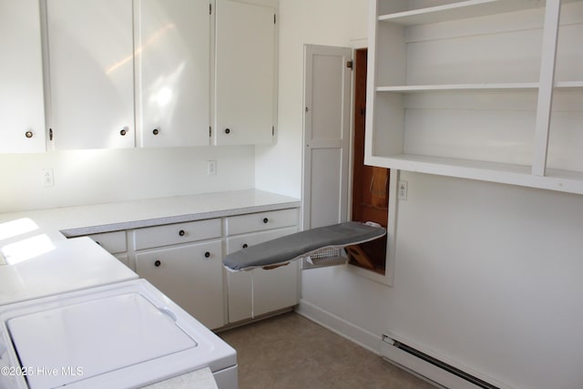 kitchen featuring a baseboard heating unit, light countertops, white cabinetry, and washer and clothes dryer