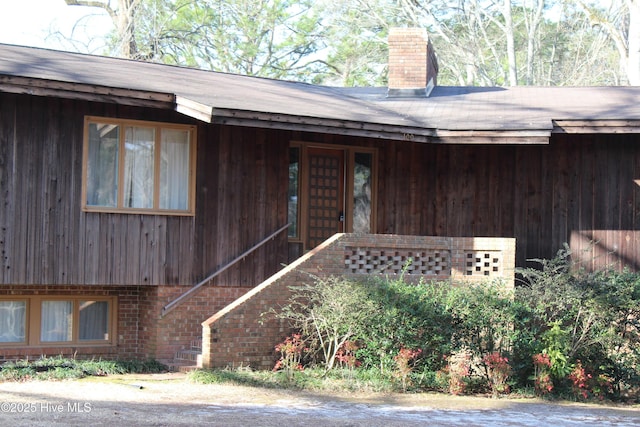 property entrance featuring a chimney