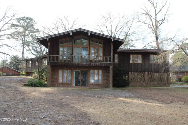 back of property featuring brick siding