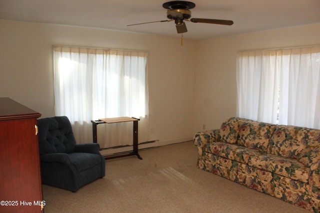 interior space featuring baseboard heating, carpet flooring, and a ceiling fan