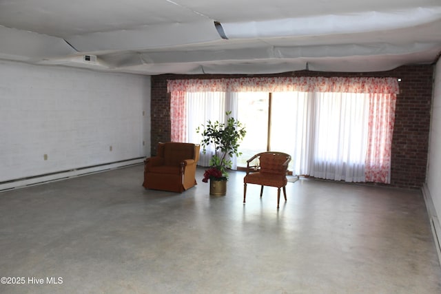 unfurnished room featuring finished concrete flooring, visible vents, brick wall, and a baseboard radiator