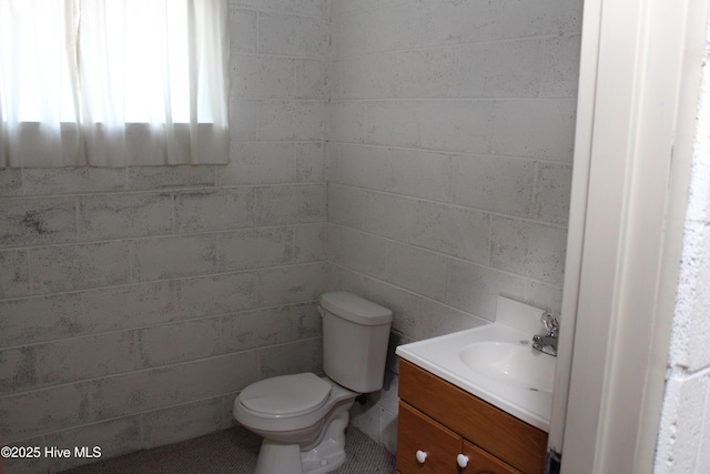 bathroom featuring toilet and vanity